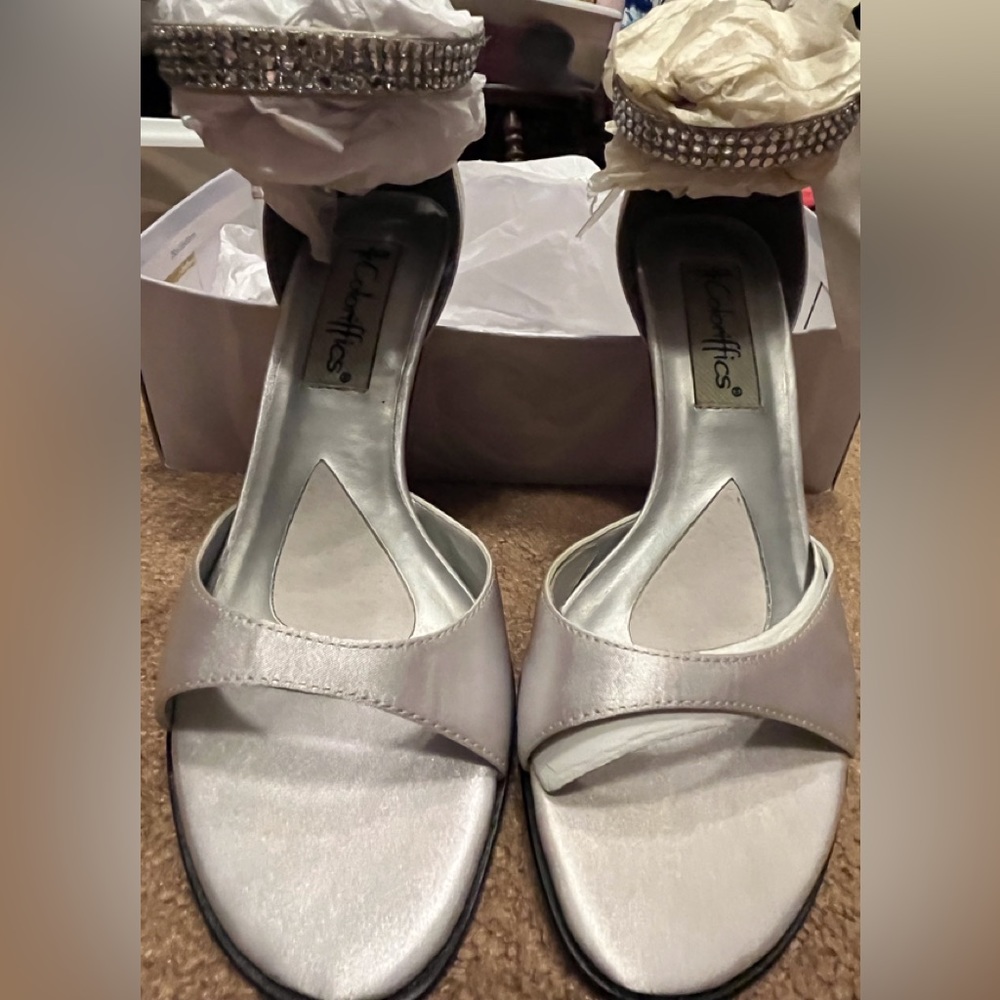 Size 6.5 new in box silver satin heels with rhinestones and ribbon bow.